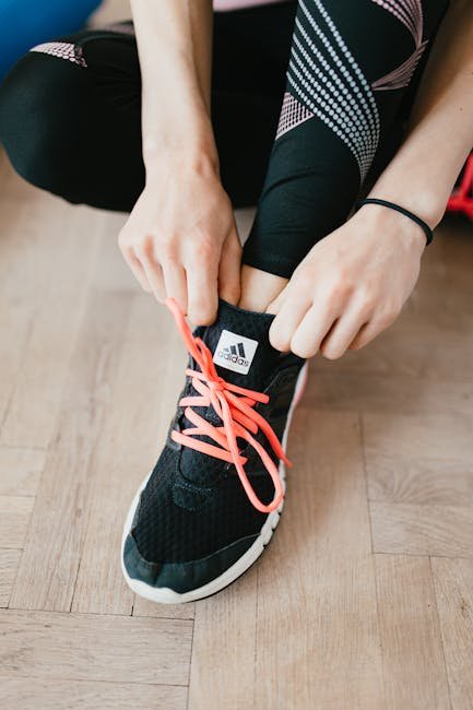 Woman setting out running shoes and clothes by the bedroom door at sunrise.