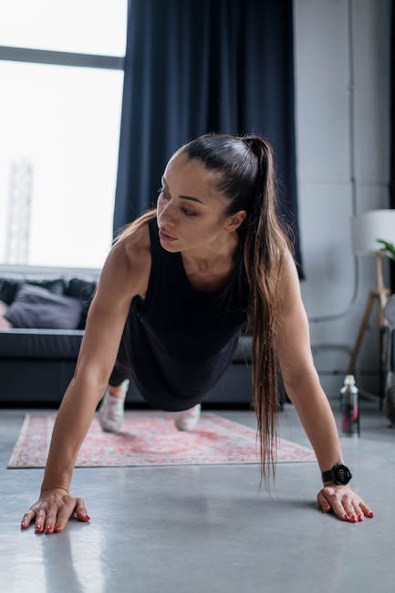 Man doing push-ups on a living room mat at sunrise, focused and composed.