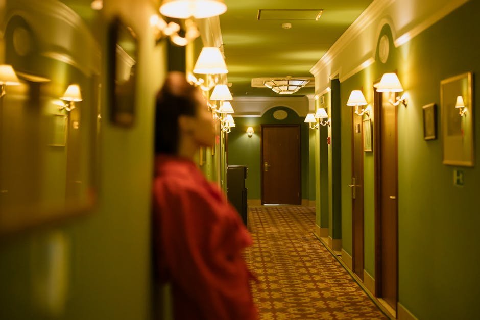 Traveler stretching in a hotel corridor, keeping the habit alive on the road.