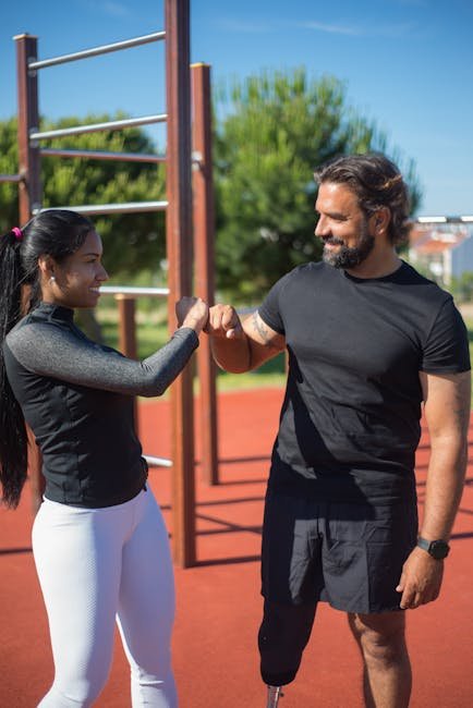 Workout partners cementing accountability with a sunset fist-bump.