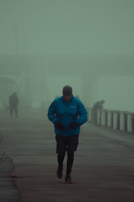 Young man jogging in cold weather in the early morning